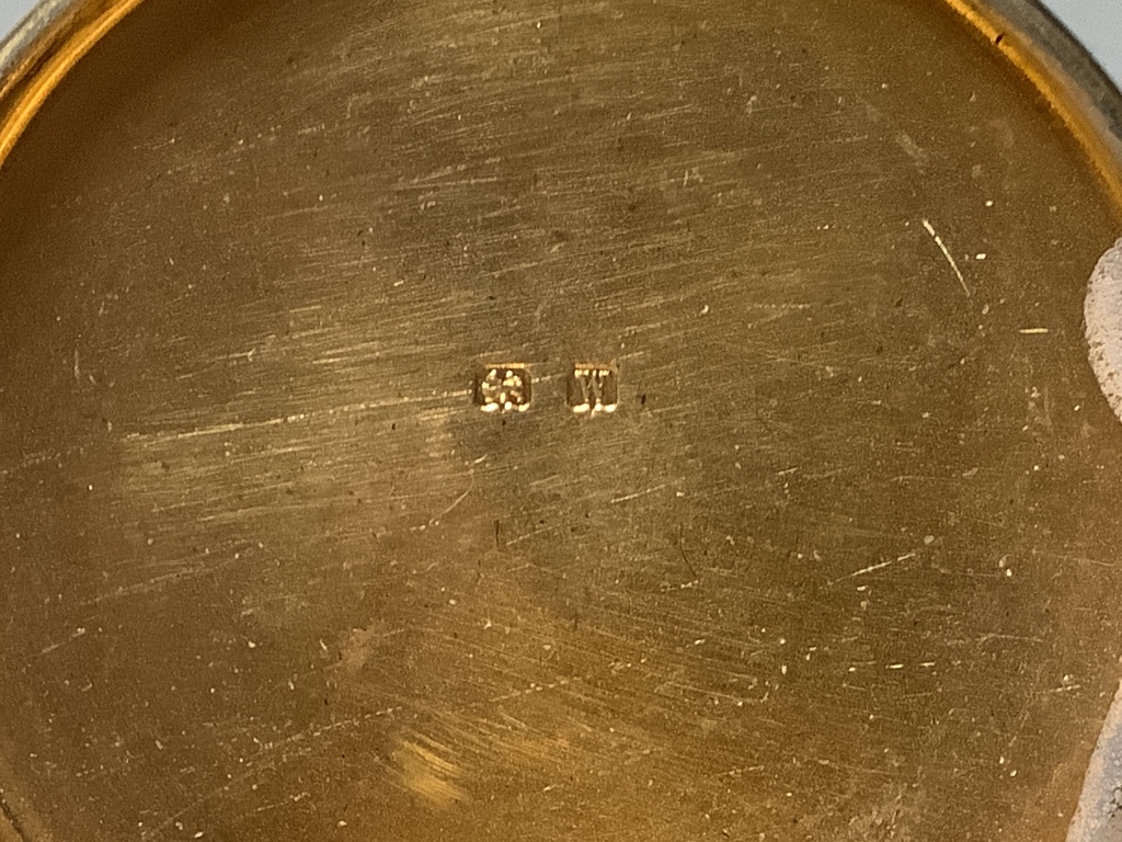 A pair of George V circular silver gilt pill boxes by Asprey Ltd, Birmingham, 1921, 47 mm, together with a silver mounted glass cayenne pepper jar with figural lid.